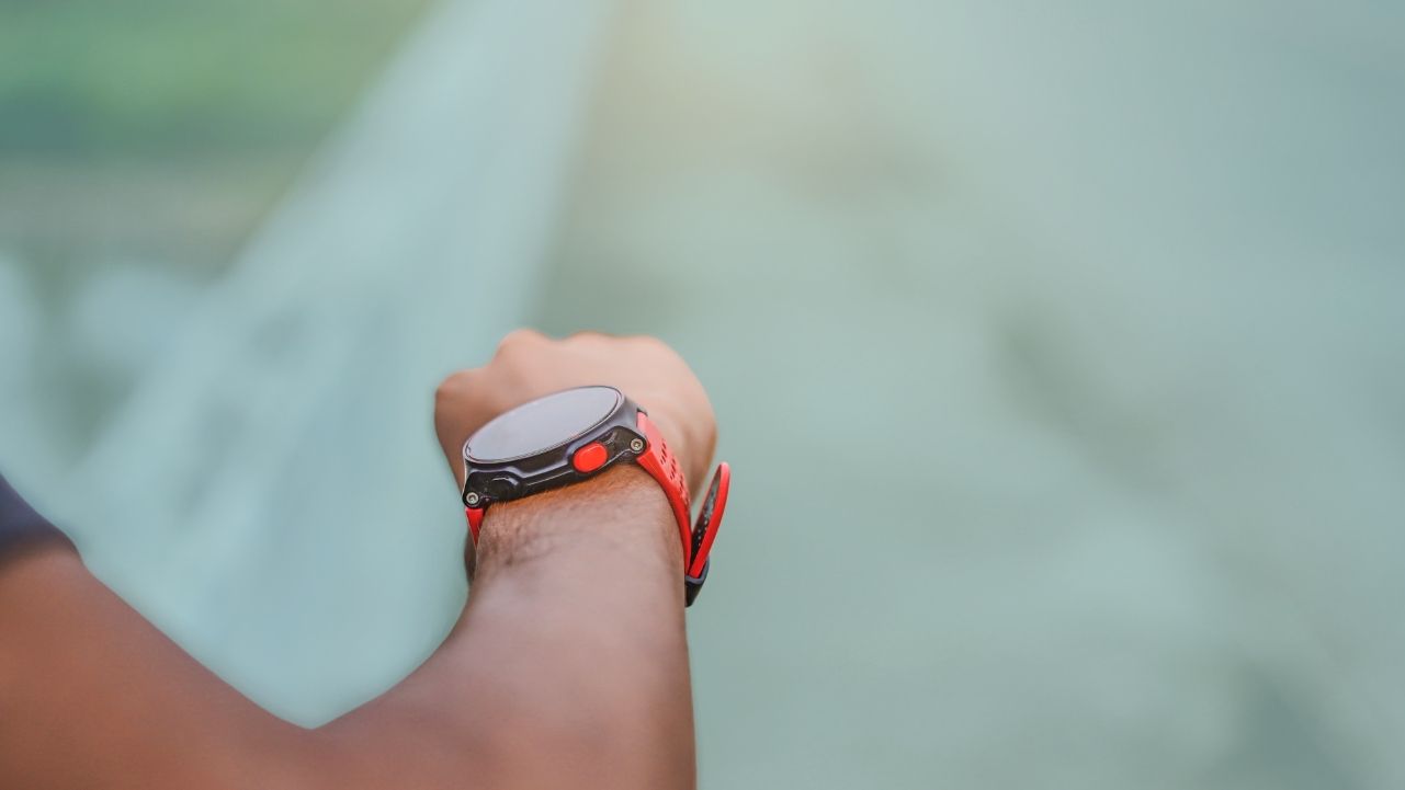 Man looking at a Apple Watch to track his fitness and sleep