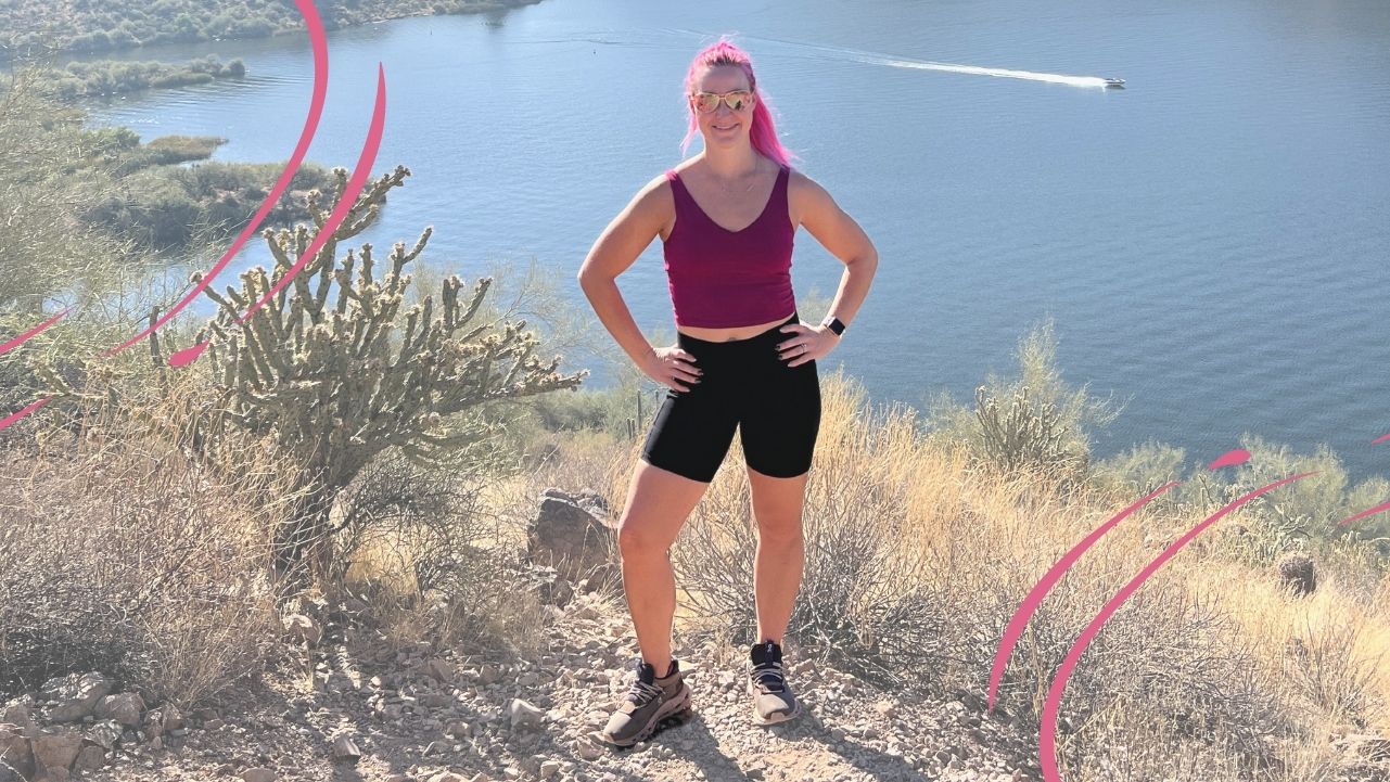 Pilatesbody by Kayla standing on a mountain in arizona with her apple watch