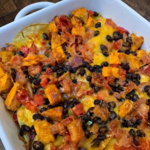 Sweet potato and black bean casserole in a white dish.