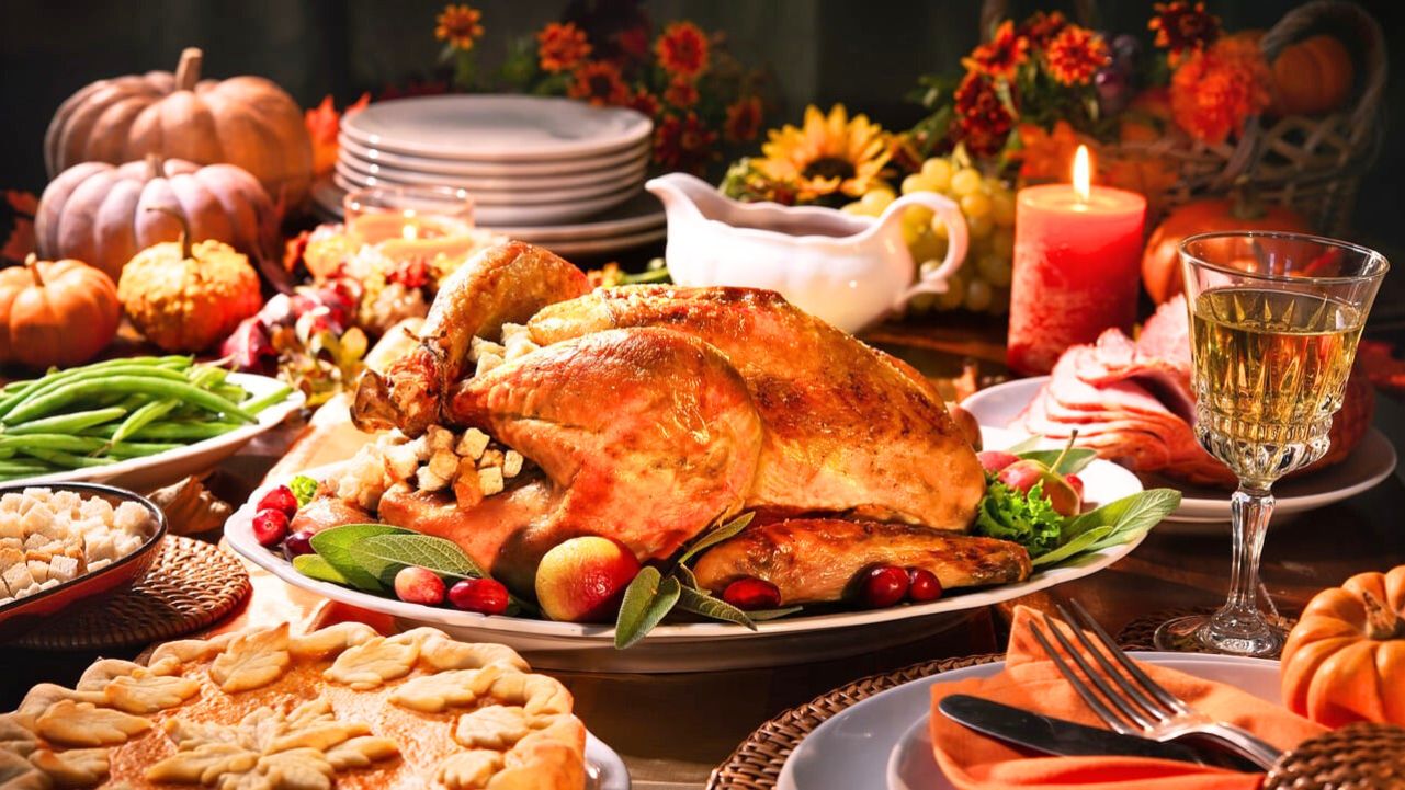 Festive Thanksgiving dinner table with roasted turkey, seasonal sides, and fall decorations, ideal for inspiring healthy leftover turkey recipes.