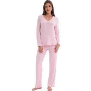 A woman wearing a cozy pink pajama set.