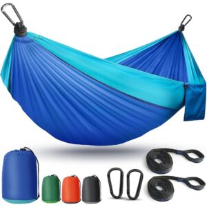 A blue hammock perfect for relaxing on a camping trip.