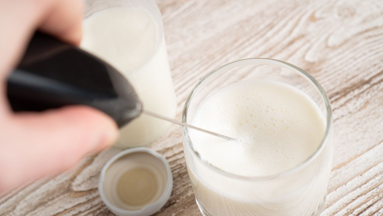Bloom Colostrum and Collagen supplement mixed into a drink.