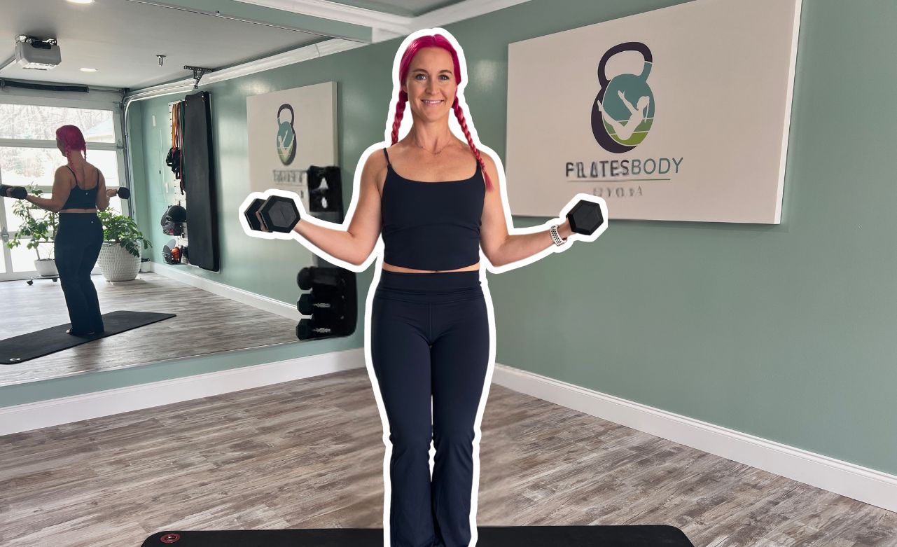 grip-strength-exercises Pilatesbody by Kayla holding dumbbells during a home workout while demonstrating how to build grip strength