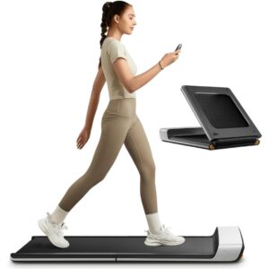 foldable-walking-pad A woman holding a remote control while walking on a foldable walking pad.